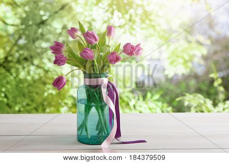 Beautiful flowers bouquet background. Violet tulips at summer garden background with copy space. Mockup for greeting card