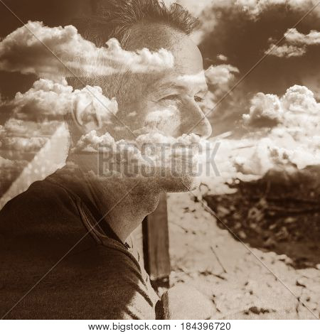 Multi exposure portrait of a thinking man with clouds on the background. Concept - meditation and serenity despite the problems.