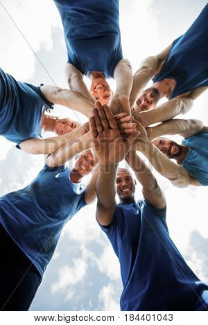 Fit people with hands stacked in the bootcamp