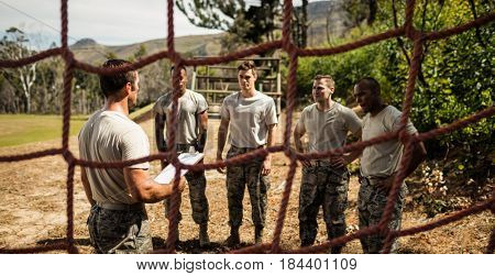 Male trainer instructing soldiers in the bootcamp