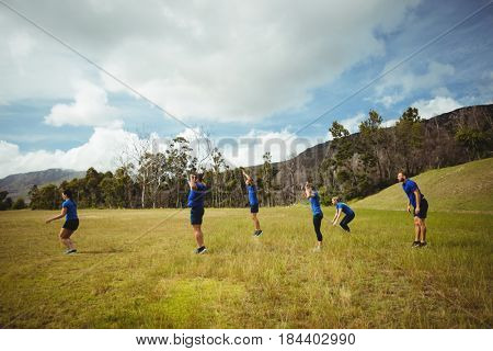 Fit people performing stretching exercise in bootcamp