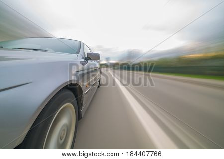 Front side view of black car with heavy blurred motion.