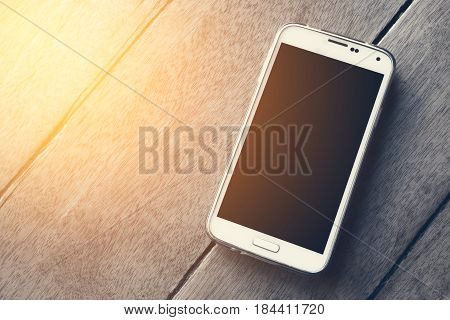 Smart phone on the wood background wallpaper