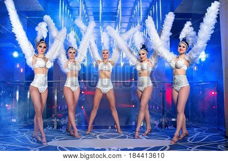Full length shot of five gorgeous women dancing wearing white carnival outfits nightclub festival festive disco dance performance showgirls show time entertainment leisure enjoyment happiness.