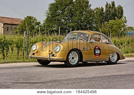 FORLI, ITALY - MAY 13: driver and co-driver on a vintage German car Porsche 356 Carrera 1500 GS/GT (1957) in classic car race Mille Miglia 2011, re-enactment of the old italian race (1927-1957) on May 13, 2011 in Forli, Italy
