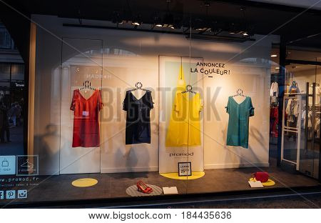 STRASBOURG, FRANCE - APR 27, 2017: Promod fashion clothing store with multi colored dresses in the vitrines illuminated by spotlight