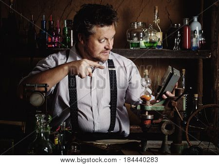 crazy medieval scientist working in his laboratory