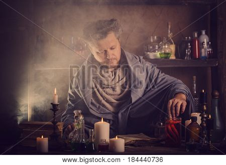 the portrait of  alchemist at the table