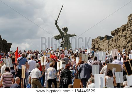 Volgograd Russia - May 9 2016: Procession of local people with photos of their relatives in Immortal Regiment on annual Victory Day on Mamaev Hill in Volgograd
