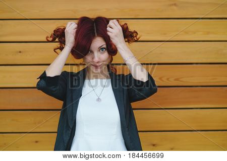 Portrait Of A Girl With Red On A Wooden Wall Background