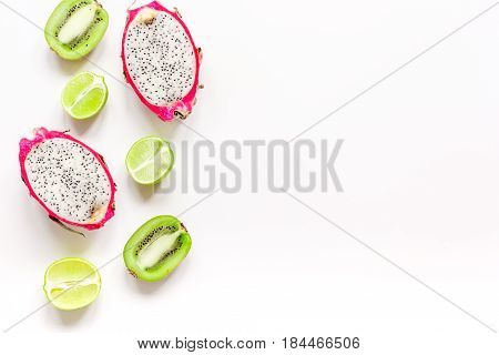 summer pattern with kiwi and pitaya on white desk background top view mock up