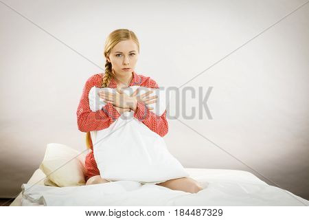 Sad Depressed Girl In Bed Gripping Pillow