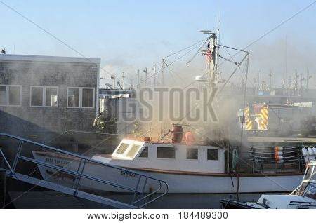 New Bedford Massachusetts USA - May 2 2017: Firefighters prepare to put out fire aboard lobsterboat 