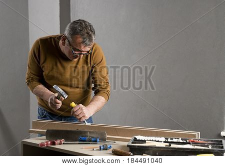 Carpenter Carving Plank with Chiesel