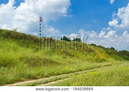 Landscape with rural road and sign no anchorage on the land.