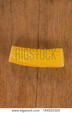 Sedani rigati pasta isolated on wooden table