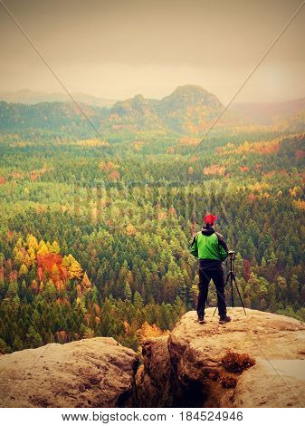 Photographer Working With Mirror Camera And Tripod On Peak Of Rock. Dreamy Fogy Landscape