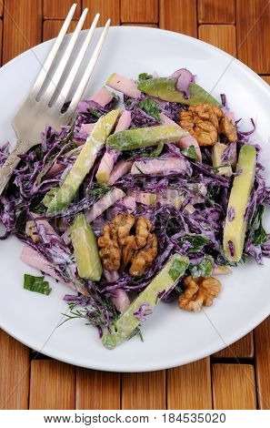 salad red coleslaw with slices of avocado apple nuts parsley dill seasoned yoghurt sauce
