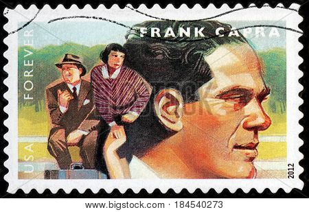 LUGA RUSSIA - APRIL 26 2017: A stamp printed by USA shows famous American film director Frank Capra and Clark Gable Claudette Colbert starring in comedy film It Happened One Night circa 2012