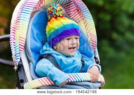 Baby Boy In Stroller In Autumn Park