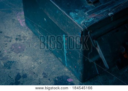 Ancient military ammunition box on ground in vintage style
