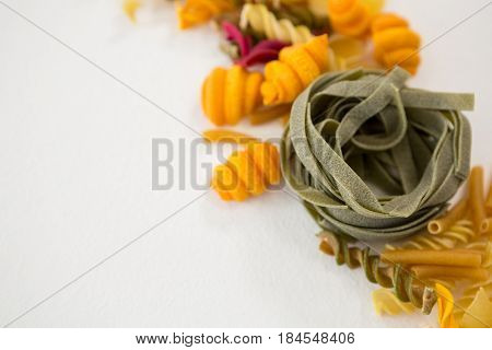 Close-up of various pasta arranged on white background