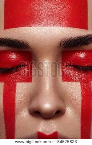Beauty Woman with red Forms on Face and closed Eyes