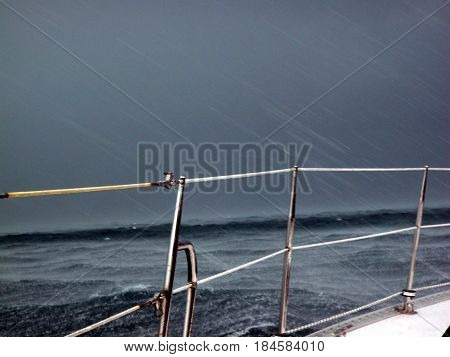 Storm squall and rain while sailing in the ocean