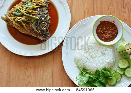 fried mango fish head dressing ginger soy sauce eat with rice and spicy shrimp paste sauce