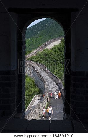 Mutianyu China - July 30 2012: Tourists walking in a stretch of the Great Wall of China in Mutianyu China