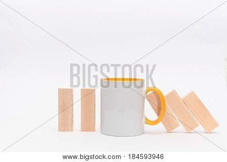A cup of tea or coffee stop the Domino principle. Business concept. On a white background. Horizontally.