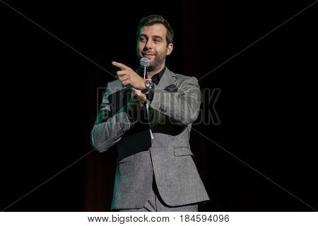 Moscow, Russia - April 24, 2017: Famous Russian showman Ivan Urgant performs at Synergy Global Forum at Crocus Expo Hall. This is one of the largest business forums with more than 5000 participants