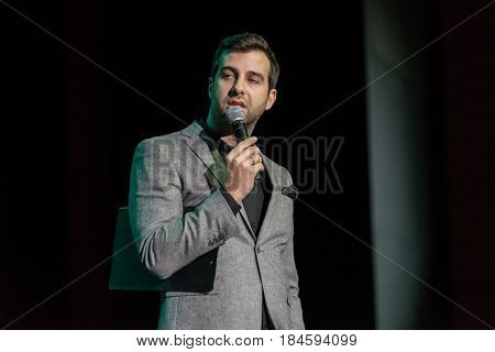 Moscow, Russia - April 24, 2017: Famous Russian showman Ivan Urgant performs at Synergy Global Forum at Crocus Expo Hall. This is one of the largest business forums with more than 5000 participants