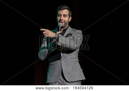 Moscow, Russia - April 24, 2017: Famous Russian showman Ivan Urgant performs at Synergy Global Forum at Crocus Expo Hall. This is one of the largest business forums with more than 5000 participants