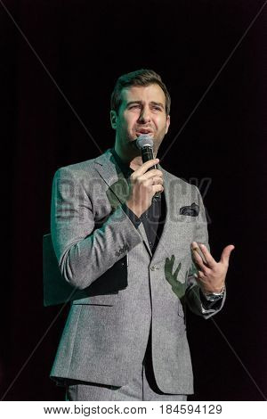 Moscow, Russia - April 24, 2017: Famous Russian showman Ivan Urgant performs at Synergy Global Forum at Crocus Expo Hall. This is one of the largest business forums with more than 5000 participants