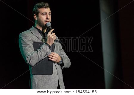Moscow, Russia - April 24, 2017: Famous Russian showman Ivan Urgant performs at Synergy Global Forum at Crocus Expo Hall. This is one of the largest business forums with more than 5000 participants