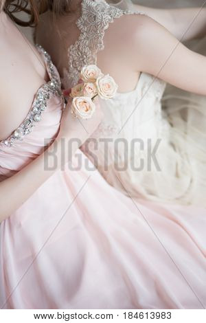 Blurred image in pink beige pastel colors background two tender girls models in Veil Wedding Dress. Boudoir photography. Selective focus. High key