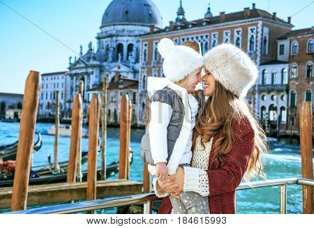 Mother And Daughter Tourists On Embankment In Venice, Italy