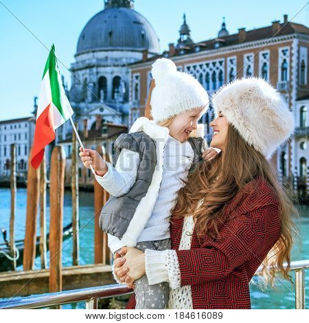 Mother And Child Travellers In Venice, Italy With Italian Flag