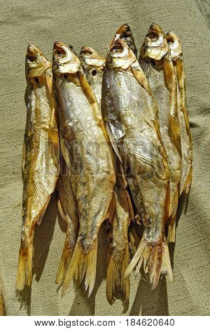 Freshwater fish cold-smoking vendace lie on canvas