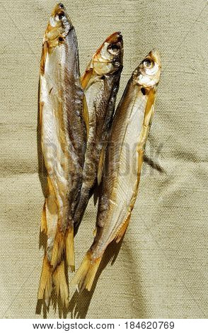 Freshwater fish cold-smoking vendace lie on canvas