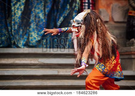 Dancer in demon Rangda traditional mask - evil spirit of Bali isalnd. Temple ritual dance at ceremony before Balinese silence day Nyepi. Religious festivals art ethnic culture of Indonesian people.