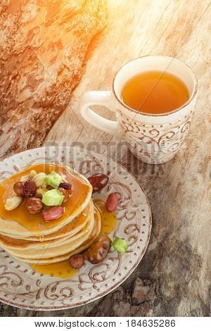 Stack Of Hot Pancakes With Nuts, Dried Fruits And Caramel Syrup.