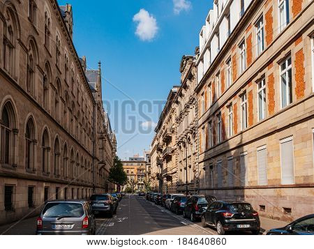 STRASBOURG FRANCE - APR 27 2017: Rue Wencker street with typical French architecture apartment buildings and cars parked on the trottoir