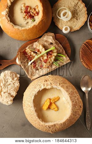 Delicious cream soup in bread on table