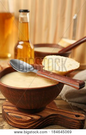 Delicious cream soup with bread on table