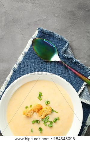 Delicious cream soup on table, top view