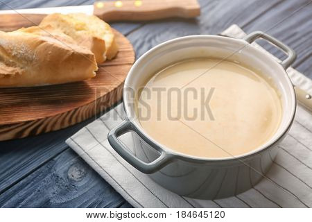 Delicious cream soup in pan on table