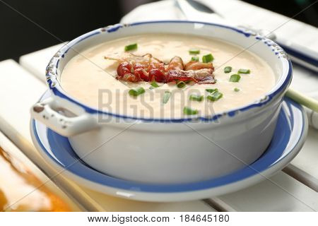 Delicious cream soup with bacon and onion, closeup