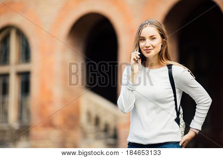 Happy Student Girl Speaking Mobile Outdoors Near University